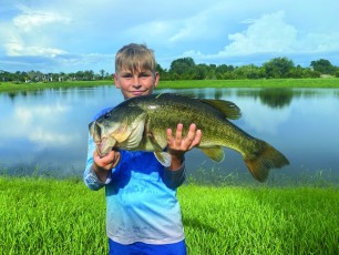 Taran Eades showing off his monster bass, caught near Ft. Hammer.