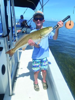9 yo Cash caught this beautiful red out fishing with his dad.