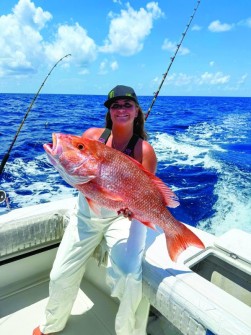Alexis Cummings w/ a red snapper caught aboard the “chuck wagon” out of Dunedin w/ Capt. Mike Skinner at “By Request Charters.”