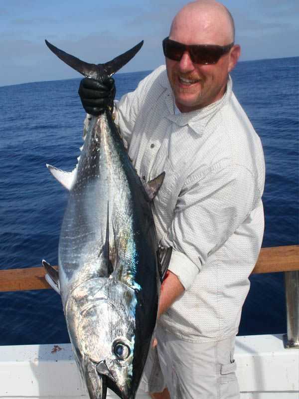 Rob Bellrose of Lompoc, CA shows off a nice bluefin tuna caught aboard the Searcher out of Fishermans Landing in San Diego.