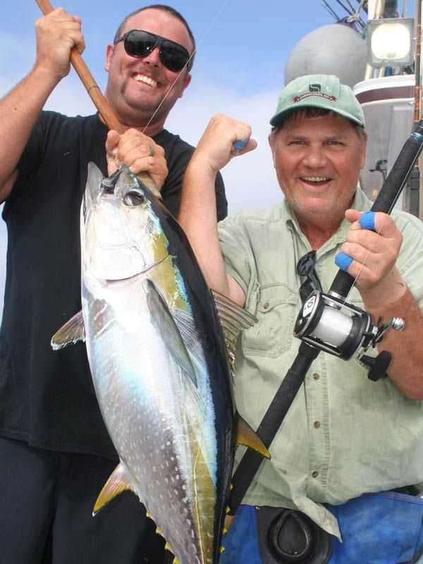  Both angler Charles Dominique of Las Vegas [R] and Searcher crewman Aaron Remy are fired up about this 30-pound yellowfin tuna caught during the recent Penn 6-day long-range adventure.
