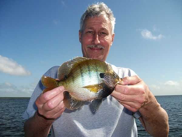 Brian Smith from Indiana and a big Okeechobee blue gill. PHOTO CREDIT: Capt. Mike Shellen.