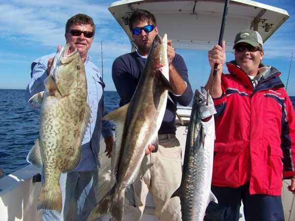Photo from left to right: Capt Tim Barefoot with a nice Gag, Matt Perkins with a Cobia, Eddie Hardgrove,  CAM co-publisher, with a King mackerel. 