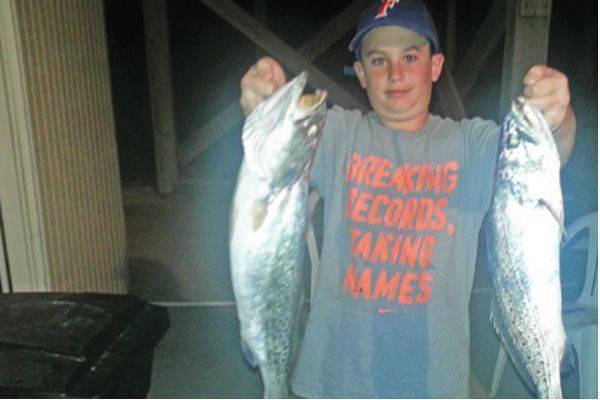 Ethan Edge with a 24 and 22 inch trout caught in Apalachicola Bay.