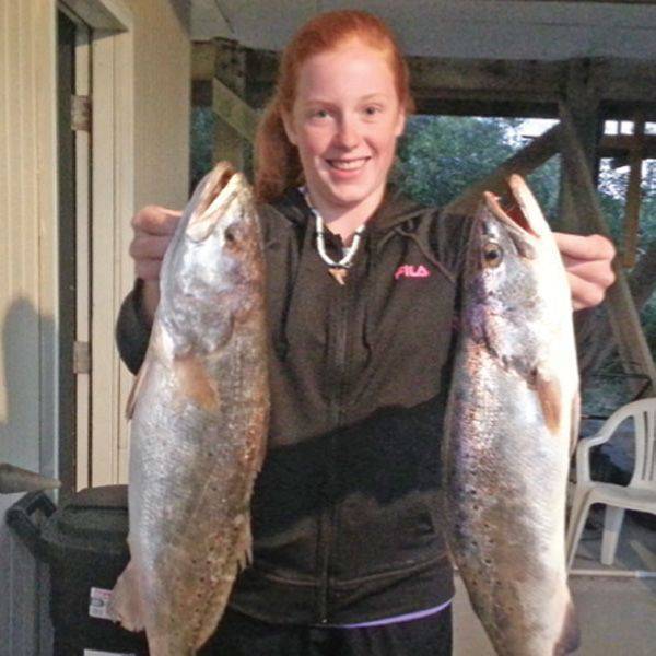 Sara Higgins with twin 24 inch trout caught in Apalachicola Bay.