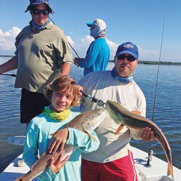 Father and son with twin red fish!