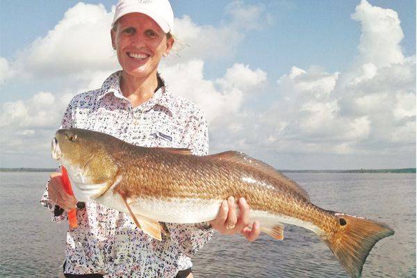 Dee, visiting from Tampa, with her first red fish ever!