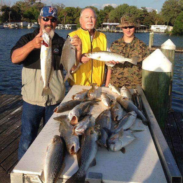Capt. Charlie Harris and Capt. Kelly Kofmehl and clients with pompano, trout and spanish mackerel 