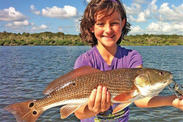 Chloe from Orlando caught her first Redfish at Mosquito Lagoon with Capt Michael Savedow.