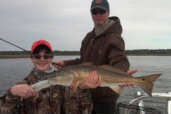 Colby Ackerman and his dad show off his first redfish ,a 28.5” 7.5 lb. brute!