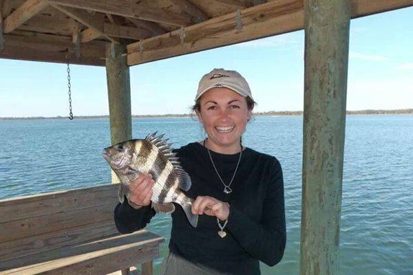 Cassie Mander showing off a sheepshead she patiently fed a live shrimp.