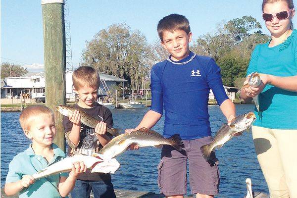 Trenton, Levi, Kelly, and Sydney Kofmehl with dinner.