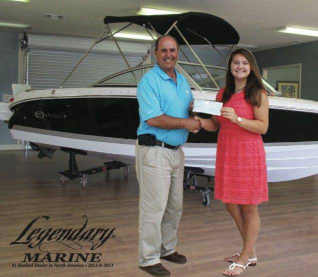 Panama City student Avalon Dudinsky of North Bay Charter High School receives her Legendary Marine Scholarship Award from Legendary Marine General Manager Nick Martrain of the Panama City dealership.  