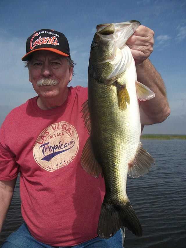 PHOTO: Dan Shipman from California and a big Okee bass. PHOTO CREDIT: Capt. Mike Shellen.