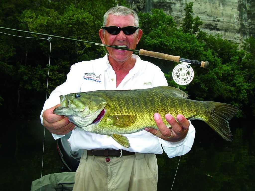 NROC client John Harrison with a topwater smallmouth caught on the fly.