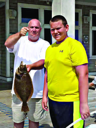 Richard Wilcox and son with a nice flounder.