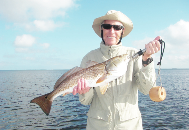 Alan is thrilled with his birth- day presents as he catches some redfish with Capt. Mark Wright.