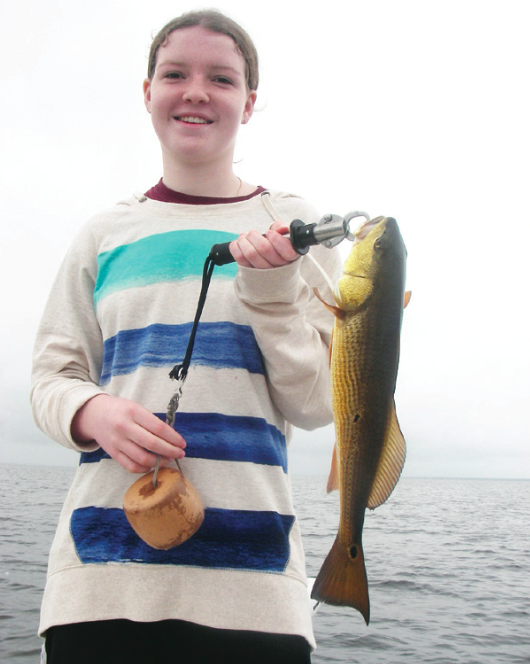 Sis with her red taken on cut mullet while fishing with Capt. Mark Wright. 