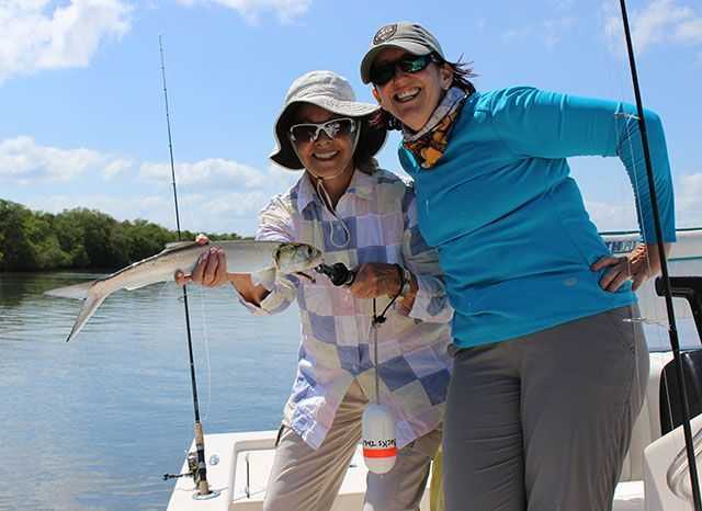 Carole Berk, with Capt. Melinda Buckley, proud of a 20-inch ladyfish caught on Buck’s Tale at the “Ladies, Let’s Go Fishing!” Treasure Coast University May 16-18, 2014.