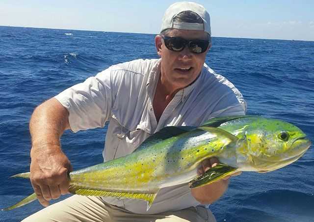 Pastor Darrell Orman praising the Lord with an 11-pound mahi caught trolling a naked ballyhoo in 350 feet of water out of the St. Lucie Inlet. PHOTO SUBMITTED by Darrell Orman.