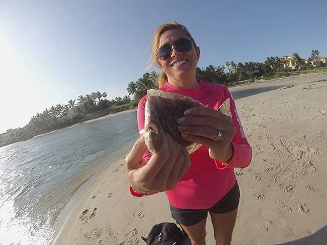 Regina Danielson with a flounder she caught on a Yo-Zuri Crystal Minnow at the St. Lucie Inlet. PHOTO CREDIT: Chris Sharp.