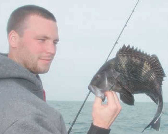 The author’s son, Ryan Schlichter, with a nice sea bass caught on light jigging gear.