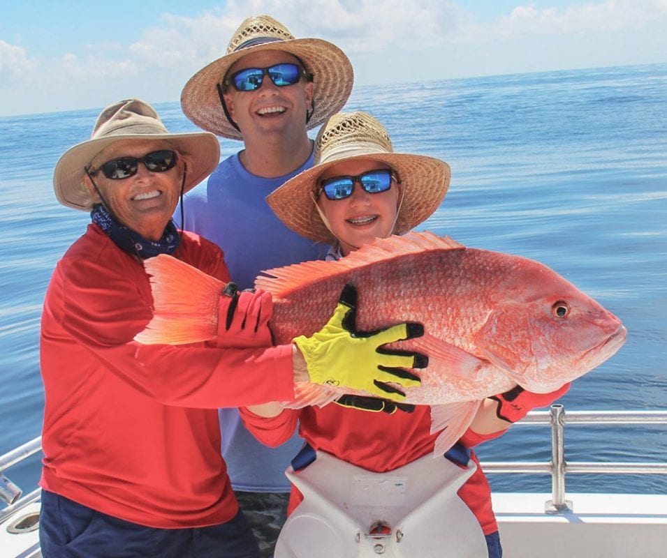Captain Judy, Alli Cat DeYoung holding genuine red snapper