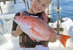Brantley, 6, shows off the red snapper he took out of Sebastian.