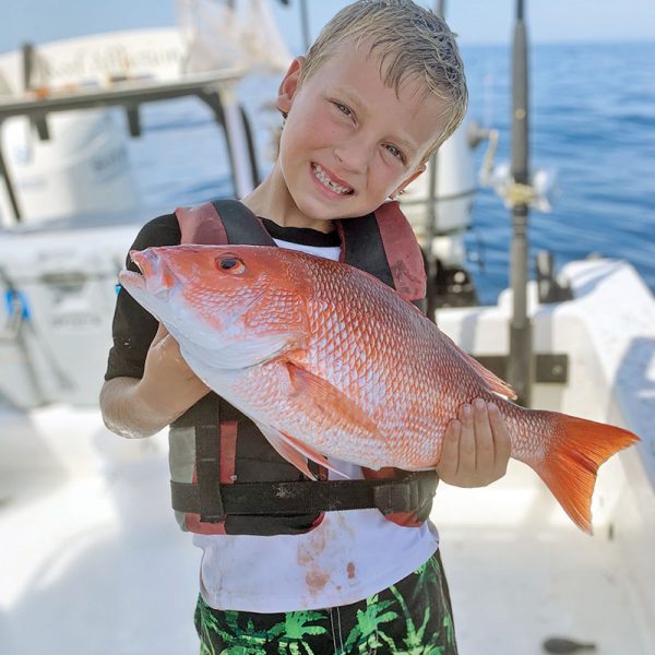 Brantley, 6, shows off the red snapper he took out of Sebastian.