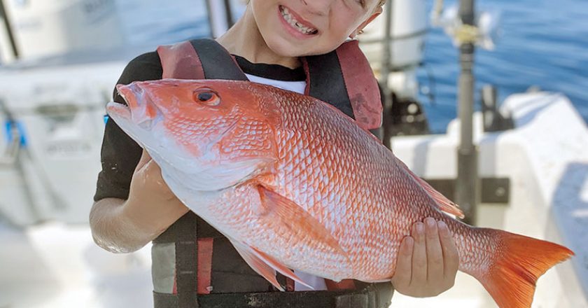 Brantley, 6, shows off the red snapper he took out of Sebastian.