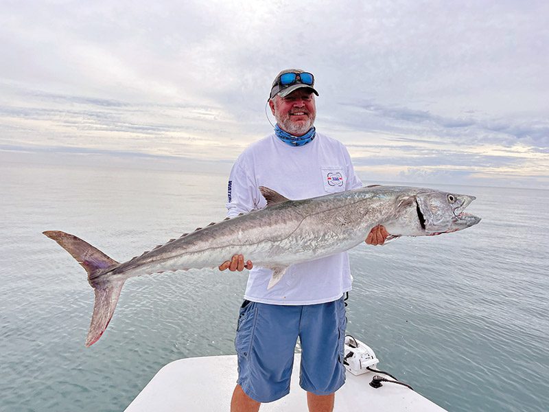 Mark Coomber with a 51lb. kingfish he caught while fishing in 12’ of water off the beach for tarpon on soft plastics.