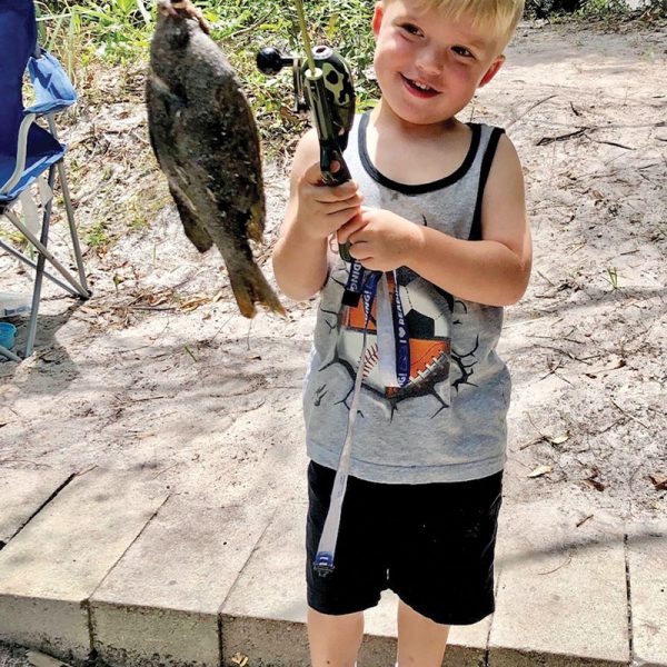 Four-year-old Sawyer Bass caught his first 10-inch sunfish using worms in a canal in Canaveral Groves.