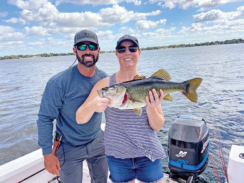 Amy and her first fish ever, a trophy 9 lb. largemouth bass caught on an artificial lure!