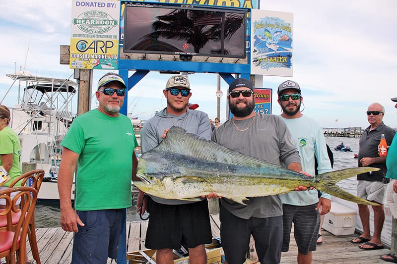 Crew aboard The Other Woman—Doug Relick, Blake Relick, Code Scholer and Clayton Schlitt— with their 31.38 pound first place mahi mahi. (Not pictured, Rory Mueller.)