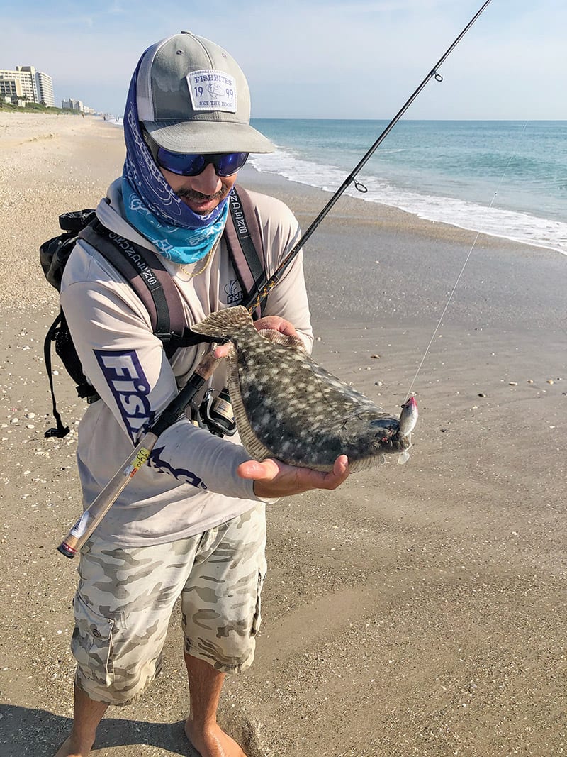 Capt. Lukas with a surf-fishing flounder.