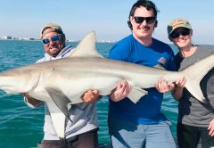 The strain is real as this great couple from Minnesota and Capt. Joe hoist up 6.5ft, 125 lbs. of full grown black tip shark as it turns to smile at the camera!