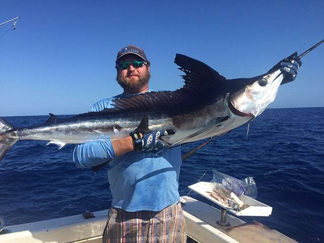 Capt. Travis Kelly with a white marlin recently caught in Abaco and released. PHOTO CREDIT: Gusto Charters and Guide Service.