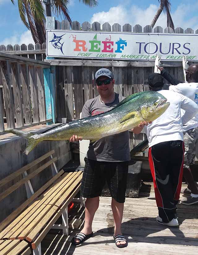 The dolphin bite in Grand Bahama waters is still strong, as proven by a happy guest of Reef Tours. PHOTO CREDIT: Reef Tours.