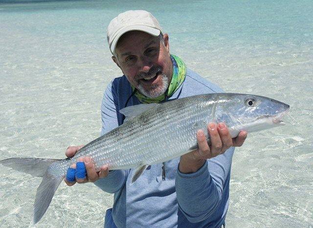 Richard Cambia on the flats of East Grand Bahama with a nice bonefish. PHOTO CREDIT: Firefly Bonefishing.