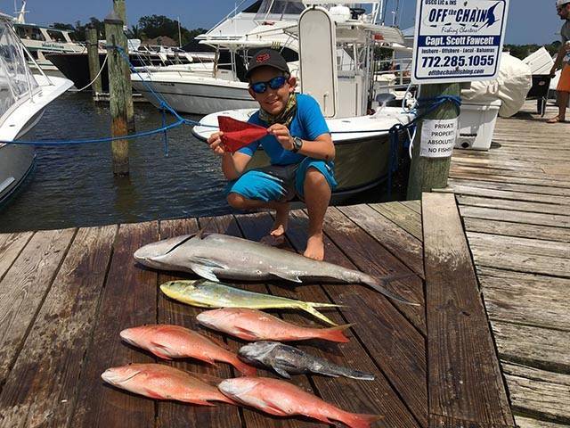 Logan Salles, 12, with a nice catch of mutton snapper, a big seabass, a fat jack and his first ever sailfish release! Logan, his dad and grandpa also caught some yellowfin tuna, blackfin tuna, sharks, jacks, seabass, snapper, triggerfish, grouper and missed a blue marlin on their two days of fishing with Capt Scott. PHOTO CREDIT: Capt. Scott Fawcett.