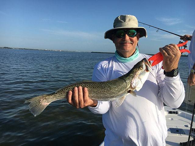 Rusty with an over slot trout caught on the grass flats in Fort Pierce. PHOTO CREDIT: Capt. Charlie Conner.