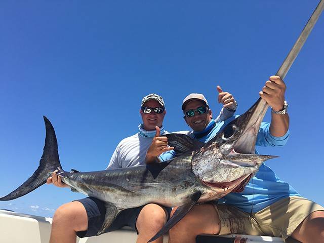 Louis Devaleix and Cory Hanlon with a beautiful swordfish they caught while fishing with Capt Scott Fawcett from Off the Chain Fishing Charters. PHOTO CREDIT: Capt. Scott Fawcett.