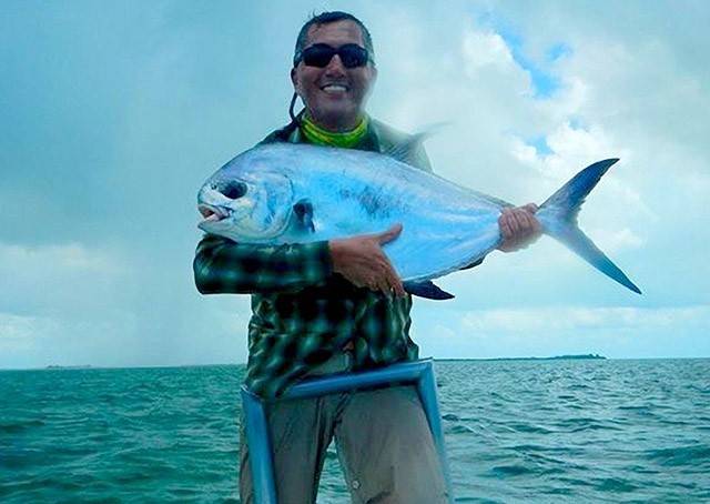 Patricio Lacaruso first time fishing in salt water with one of the two permit he caught on the fly while fishing the flats of Eastern Grand Bahama. PHOTO CREDIT: Firefly Bonefishing.