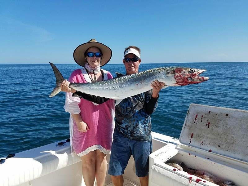 Capt. Bill Stewart of the Rogue Wave with CJ and her nice kingfish. PHOTO CREDIT: Rogue Wave Fishing Charters.