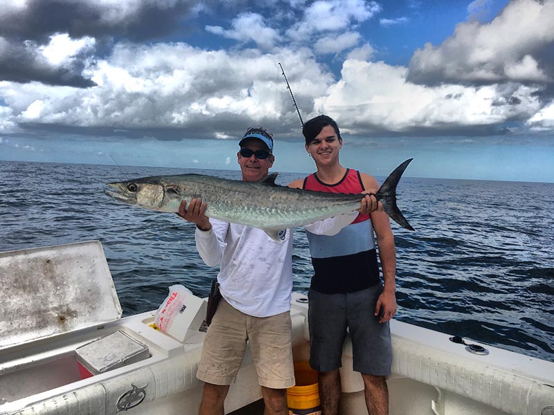 Logan Price with his first whopper kingfish caught aboard the "Rogue Wave" with Capt Bill. Not a bad way to start. Photo credit: Rogue Wave Fishing Charters.