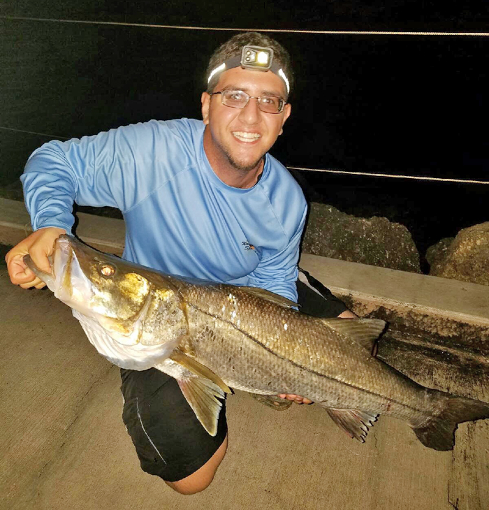 Chris Pascual with a monster snook caught late one night fishing off the Port Everglades jetty.