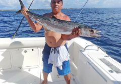 Jay Garcia with a smoker caught with Capt. Chris Dyer aboard the Gray Ghost.