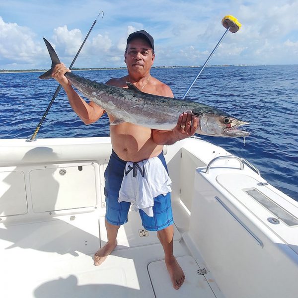 Jay Garcia with a smoker caught with Capt. Chris Dyer aboard the Gray Ghost.