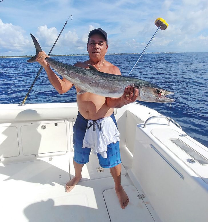 Jay Garcia with a smoker caught with Capt. Chris Dyer aboard the Gray Ghost.