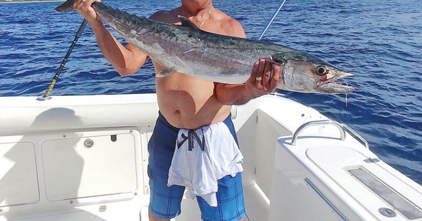 Jay Garcia with a smoker caught with Capt. Chris Dyer aboard the Gray Ghost.